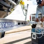 man next to boat on trailer preparing for fishing trip