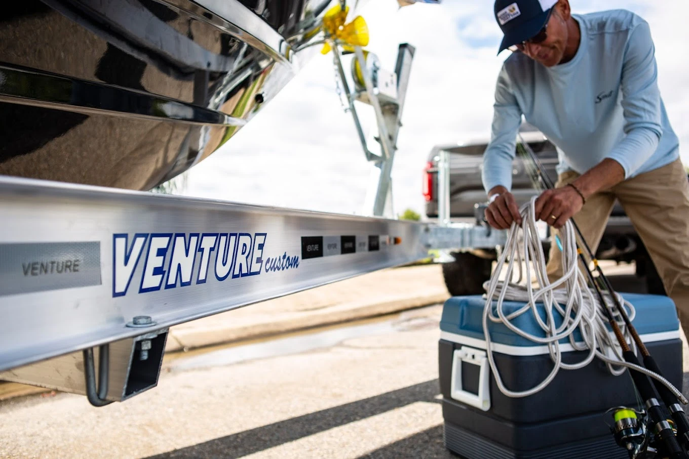 man next to boat on trailer preparing for fishing trip
