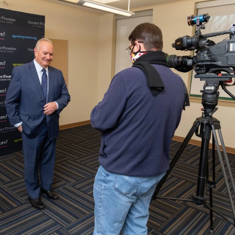 Bill McCarthy, Executive Director of Catholic Charities of Maryland preparing for a TV interview.